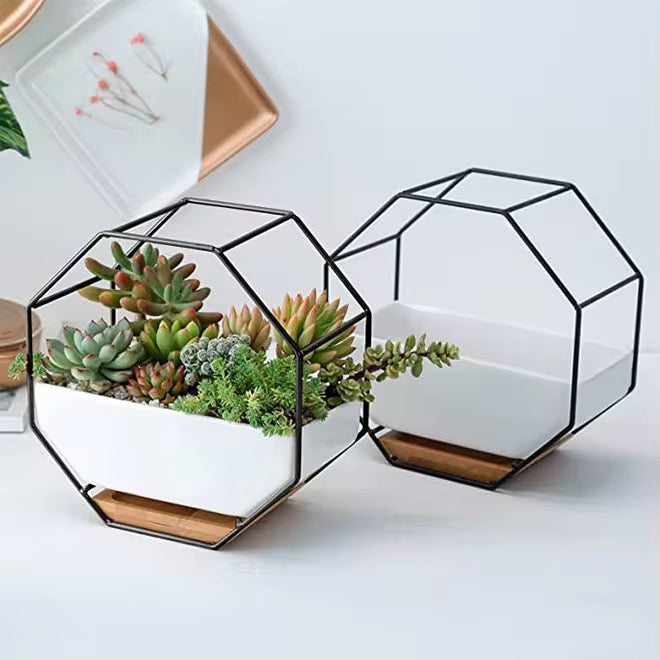 White ceramic planter with wooden base and metallic stand