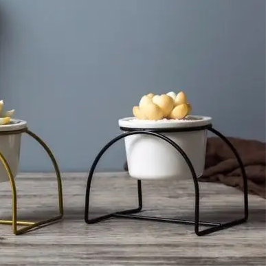 White ceramic planter with metallic stand