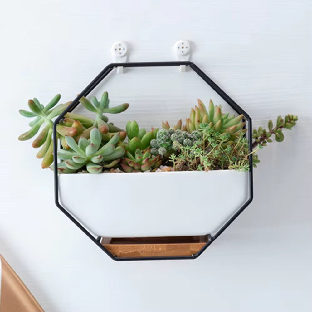 White ceramic planter with wooden base and metallic stand