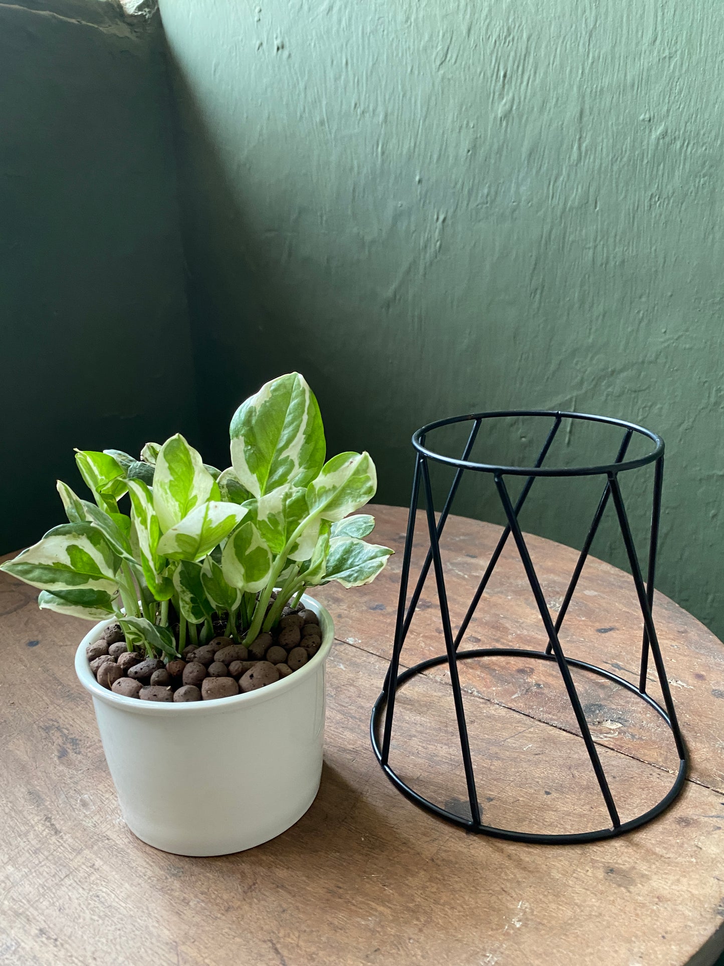 White ceramic planter with metallic stand