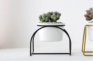 White ceramic planter with metallic stand
